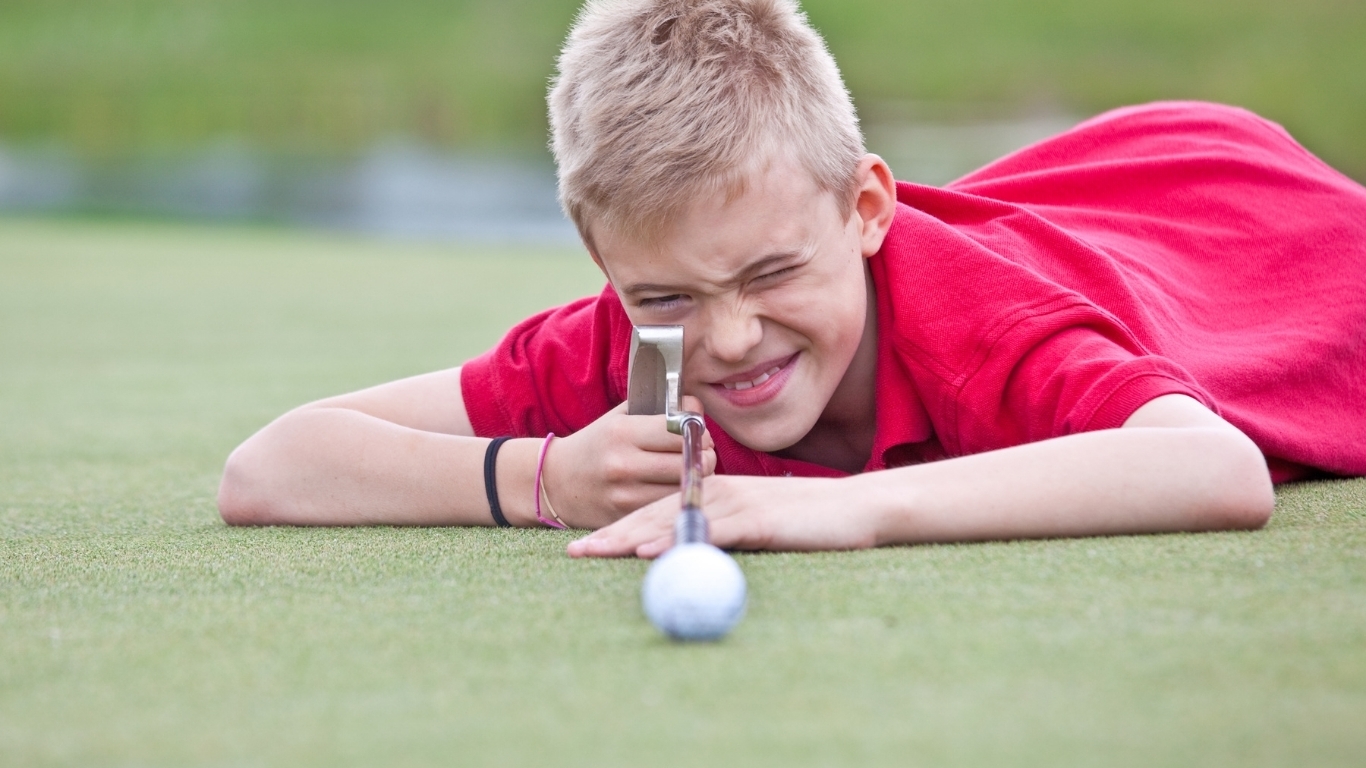 Junior golfer practicing putting